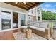 Inviting balcony featuring a cozy wicker sofa and views of the lake through sliding glass doors at 860 Jetton St # 59, Davidson, NC 28036
