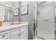 Clean bathroom with white cabinets, light gray walls and a shower with clear glass doors at 860 Jetton St # 59, Davidson, NC 28036