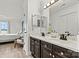 Bathroom featuring double sink vanity with marble countertops and an adjoining bedroom at 860 Jetton St # 59, Davidson, NC 28036