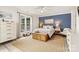 Well-lit bedroom with a blue accent wall, white linens, and bright natural light at 860 Jetton St # 59, Davidson, NC 28036