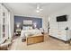 Inviting bedroom featuring a bed with white linens, blue accent wall, and modern furnishings at 860 Jetton St # 59, Davidson, NC 28036
