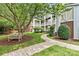 Picturesque courtyard featuring manicured landscaping, mature trees, and a tranquil bench at 860 Jetton St # 59, Davidson, NC 28036
