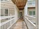 Inviting condo entrance with wooden walkway and covered porch, creating a welcoming first impression at 860 Jetton St # 59, Davidson, NC 28036