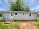 Rear exterior view of home with a patio, back door and green lawn at 908 Mccollough St, Statesville, NC 28677