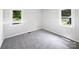 Comfortable bedroom with neutral carpet and two windows offering plenty of natural light at 908 Mccollough St, Statesville, NC 28677