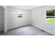 Well-lit bedroom featuring fresh carpet, fresh paint, and two windows at 908 Mccollough St, Statesville, NC 28677