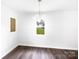 Bright dining room featuring wood floors, fresh paint, and a modern chandelier at 908 Mccollough St, Statesville, NC 28677