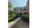 Charming townhome with brick accents, well-maintained landscaping, and inviting entryway at 9125 N Vicksburg Park Ct, Charlotte, NC 28210