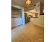Bright kitchen with stainless steel appliances, tile flooring, white cabinetry and adjacent laundry area at 9125 N Vicksburg Park Ct, Charlotte, NC 28210