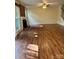 Open living room featuring hardwood floors, fireplace, and ample natural light from large windows at 9125 N Vicksburg Park Ct, Charlotte, NC 28210
