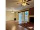 Cozy living room with fireplace, hardwood floors, and sliding glass door with backyard views at 9125 N Vicksburg Park Ct, Charlotte, NC 28210