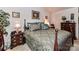 Well-lit bedroom features a large bed with decorative pillows and matching nightstands at 9337 Four Mile Creek Rd # 101, Charlotte, NC 28277