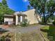 Charming home exterior with a brick patio, gravel pathway, and lush landscaping at 9337 Four Mile Creek Rd # 101, Charlotte, NC 28277
