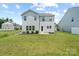 Spacious backyard with lush green grass, landscaping, and a small patio, perfect for outdoor enjoyment at 10111 Snowbell Ct, Charlotte, NC 28215