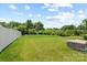 Expansive backyard featuring a well-maintained lawn, partial fence, and a small patio area at 10111 Snowbell Ct, Charlotte, NC 28215