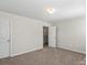 Carpeted bedroom featuring two doors and overhead lighting at 10111 Snowbell Ct, Charlotte, NC 28215