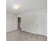A carpeted room showing a walk in closet and other features at 10111 Snowbell Ct, Charlotte, NC 28215