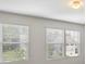 Bright bedroom featuring dual windows for natural light and soothing paint at 10111 Snowbell Ct, Charlotte, NC 28215