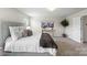 Bright bedroom features plush carpeting, a comfortable bed, abundant natural light, and stylish decor at 10111 Snowbell Ct, Charlotte, NC 28215