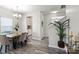 Open dining room with modern chandelier, stylish furniture, and hardwood style floors at 10111 Snowbell Ct, Charlotte, NC 28215