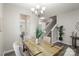 Dining room with table and chairs, views to the staircase, and hardwood style floors at 10111 Snowbell Ct, Charlotte, NC 28215