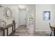 Inviting entryway with hardwood floors, a stylish mirror, and views into other rooms at 10111 Snowbell Ct, Charlotte, NC 28215