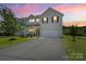 Charming two-story home featuring vinyl siding, an attached two-car garage, and a well-manicured front yard at 10111 Snowbell Ct, Charlotte, NC 28215