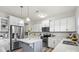Modern kitchen boasts stainless steel appliances, quartz countertops, gray subway tile backsplash, and a stylish island at 10111 Snowbell Ct, Charlotte, NC 28215