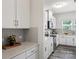 Well-lit kitchen featuring stainless steel appliances, quartz countertops, and gray subway tile backsplash at 10111 Snowbell Ct, Charlotte, NC 28215