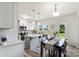 Eat-in kitchen featuring modern appliances, an island with pendant lighting, and hardwood-style flooring at 10111 Snowbell Ct, Charlotte, NC 28215