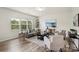 Bright living room features hardwood floors, a large window, stylish furnishings, and contemporary decor at 10111 Snowbell Ct, Charlotte, NC 28215