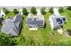 Aerial view showing a well-maintained home with solar panels, a concrete patio, and manicured lawns at 10129 Loch Lomond Dr, Charlotte, NC 28278