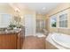 Bright bathroom with soaking tub, tiled shower, dual vanity, and neutral color scheme at 10129 Loch Lomond Dr, Charlotte, NC 28278