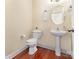 Bathroom featuring a pedestal sink, tiled floors, a mirror, a towel rack, and a toilet at 10129 Loch Lomond Dr, Charlotte, NC 28278