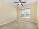Cozy bedroom featuring neutral walls, carpet, ceiling fan, and a bright window at 10129 Loch Lomond Dr, Charlotte, NC 28278