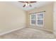 Bedroom featuring two windows, neutral walls, carpet, and a ceiling fan at 10129 Loch Lomond Dr, Charlotte, NC 28278