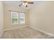 Bedroom boasting dual windows, neutral walls, carpet flooring, and a ceiling fan at 10129 Loch Lomond Dr, Charlotte, NC 28278