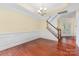 Bright dining room with cherry wood floors, a modern chandelier, and access to the stairway at 10129 Loch Lomond Dr, Charlotte, NC 28278