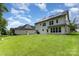 A spacious backyard with a well-maintained lawn, solar panels and patio, great for outdoor activities at 10129 Loch Lomond Dr, Charlotte, NC 28278