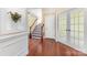 Inviting foyer with gleaming hardwood floors, classic wainscoting, and a staircase leading to the upper level at 10129 Loch Lomond Dr, Charlotte, NC 28278