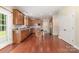 This is a spacious kitchen with wood cabinets, stainless steel appliances, granite countertops, and cherry wood floors at 10129 Loch Lomond Dr, Charlotte, NC 28278