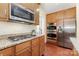 A kitchen featuring granite countertops, stainless steel appliances, tile backsplash, and wood cabinets at 10129 Loch Lomond Dr, Charlotte, NC 28278