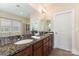 Beautiful main bathroom featuring dual sinks with granite counters, a tiled shower, and a large mirror at 10129 Loch Lomond Dr, Charlotte, NC 28278