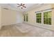Spacious main bedroom featuring a tray ceiling, ceiling fan and bright windows at 10129 Loch Lomond Dr, Charlotte, NC 28278