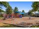Community playground with colorful play structures, swings, and a safe, cushioned ground surface at 10129 Loch Lomond Dr, Charlotte, NC 28278