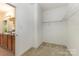 Walk-in closet with carpet flooring and wire shelving, ready for organizing your wardrobe at 10129 Loch Lomond Dr, Charlotte, NC 28278