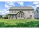 Large backyard with lush green lawn and rear house view at 10203 Loch Lomond Dr, Charlotte, NC 28278