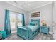Bedroom features a large window and teal accents at 10203 Loch Lomond Dr, Charlotte, NC 28278