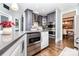 Gourmet kitchen features stainless steel appliances, gray cabinets, and hardwood flooring at 10203 Loch Lomond Dr, Charlotte, NC 28278