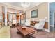 Bright living room with fireplace, dark hardwood floors, and adjacent dining area at 10203 Loch Lomond Dr, Charlotte, NC 28278